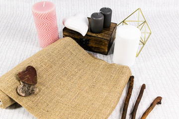Composition with candles, wood case, sticks and canvas. Love card, mockup, blank space for text.