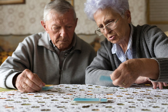 Senior couple playing cards