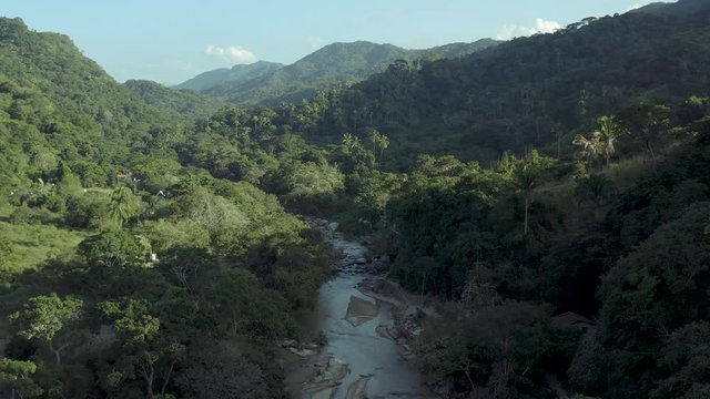 Drying river in the middle of the jungle. Aerial drone view of global warming effects.