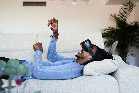 VR headset sofa playing.