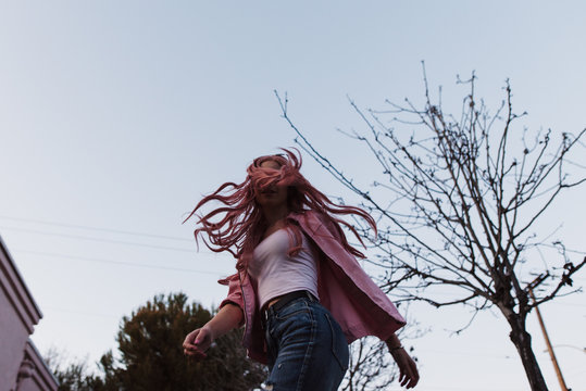 Wind blowing hair into woman's face