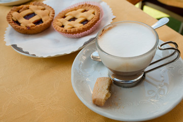 cup of coffee and cookies on wooden table