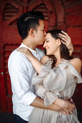 Charismatic asian guy kiss her beautiful girl with love, outdoors