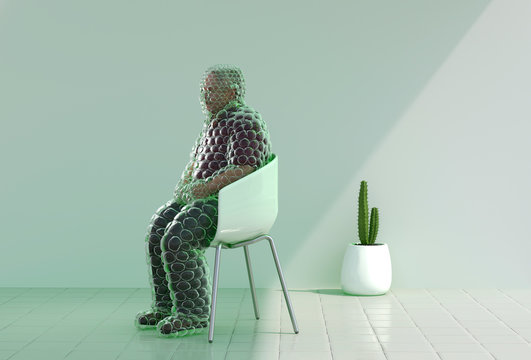 Mature man with bubble wrap sitting on chair indoors
