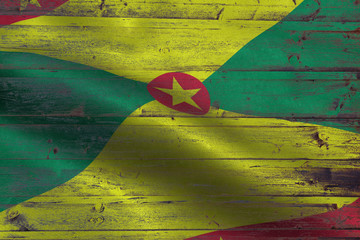 Grenada flag on an old wooden plank forming a background