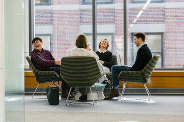 Businessman Laughing at Casual Business Meeting at Office