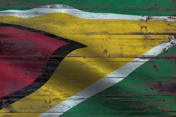Guyana flag on an old wooden plank forming a background
