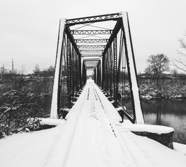 A view of an old train bridge over the White River in Indianapolis covered with snow