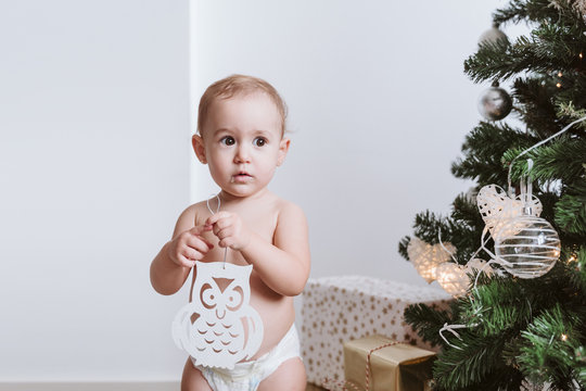 Cute Baby Girl Wearing Diaper Decorating Christmas Tree