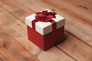 box with red ribbon and bow isolated on white