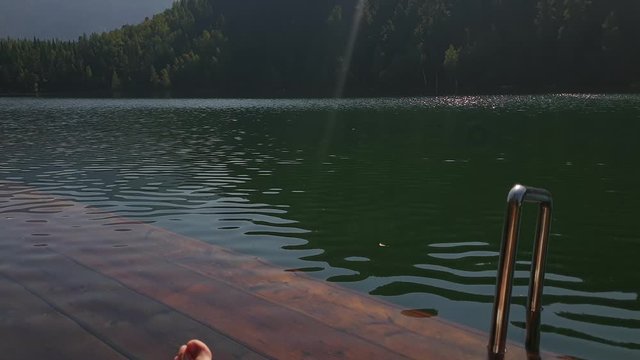 Woman shooting self portrait. Take photo and video on smartphone. Girl rest, relax, walk in sunglasses, make selfie. Lady blogger broadcast video blogging vlogging. Sunbed on pier. Pov view.