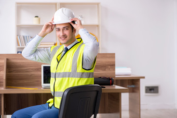 Young male architect working in the office