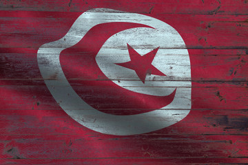 Tunisia flag on an old wooden plank forming a background