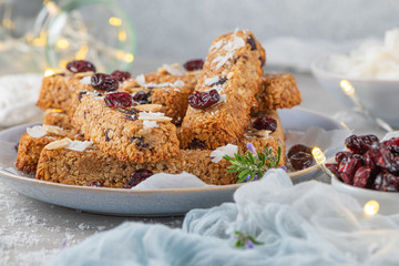 Granola bar. Healthy snack. Cereal granola bar with nuts, fruit, coconut and cranberries on a christmas table