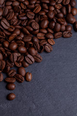 Roasted coffee beans on granite background