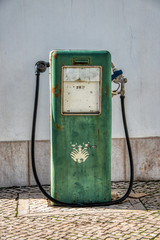A pic of a very old vintage green petrol gas pump