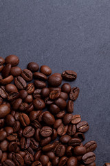 Roasted coffee beans on granite background