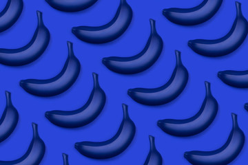 Group of blue bananas as a pattern. Flat lay style. Monochrome trendy photo ispired by color of the year 2020