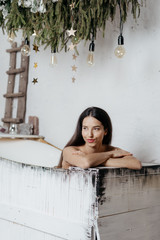 Smiling young adult girl spending weekend at home taking bath