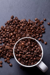 Roasted coffee beans on granite background