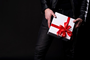 Men's hand holding gift box, holiday concept