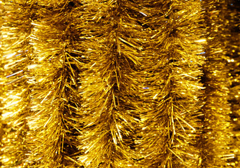 Golden Christmas fluffy garlands for decorating the Christmas tree, horizontal composition.