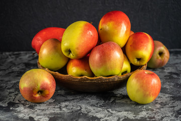 Fresh apples on a wooden plate