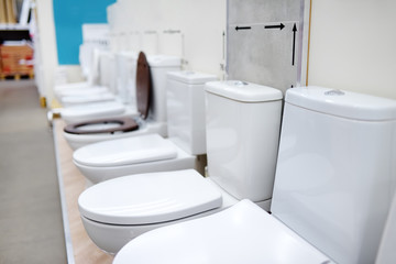 Variety toilets in construction store. Sanitary ware in hardware shop.