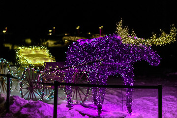 colorful moose pulling sleigh decorated for christmas