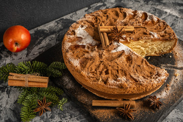 Apple pie with cinnamon on the table, Christmas fir branch on the table with cinnamon sticks and star anise