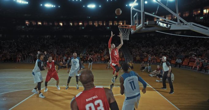 Basketball players on big professional arena during the game. Tense moment of the game. Celebration