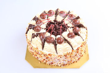 Close-up of homemade chocolate cake on brown canvas.