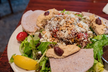 Close up shot of a plate of salad with vegetable, apple slice and onions