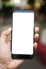 A man using a smartphone at an abstract blur clothing store Blank screen for editing in graphic displays