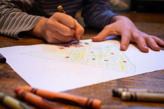 a child coloring a Christmas page