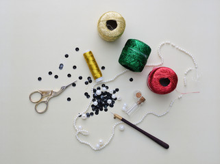 Hook, metallic fibers, scissors, pearl beads, sequins and other supplies for bead embroidery or...