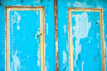 Old windows with peeling paint, details of the old house
