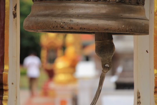 Bell with a stick in a temple, focus on bell