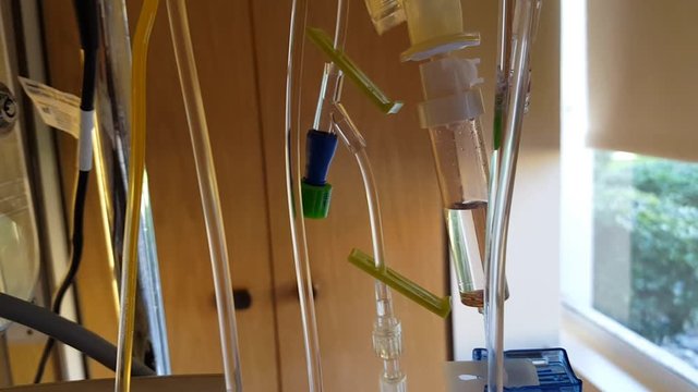 IV tubes hanging from a stand in a hospital room