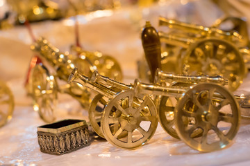 Golden metal canon antique isolated on blurred background