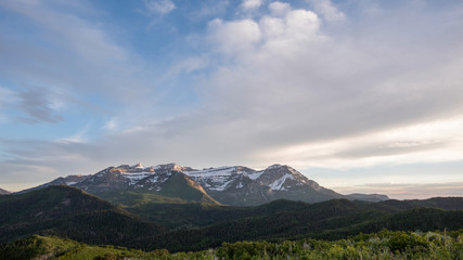 Fototapeta premium Clouds moving over Timpanogos Mountain as the light fades at sunset viewing the backside of Timp.