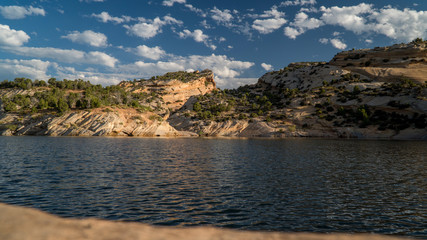 Clouds in the sky reflecting in lake at Red Fleet Reservoir in Utah.