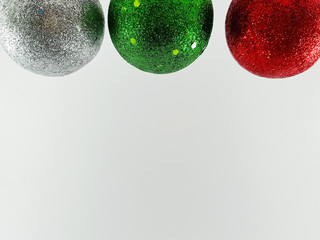 green christmas ball with red ribbon on white background