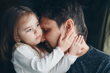 Dad holds the baby in his arms. The concept of educating the father of young children, Happy childhood, a friendly family.