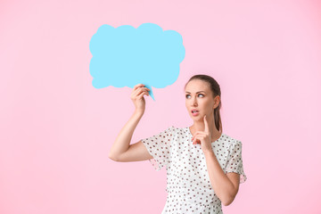 Thoughtful young woman with blank speech bubble on color background