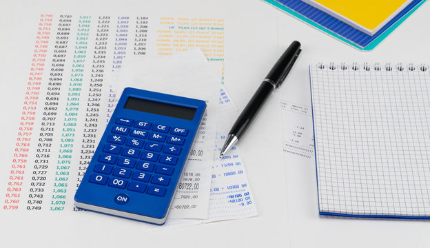 Calculator and notepad on top of supermarket receipt. Shopping and payment concept