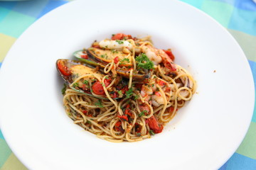 Spicy seafood spaghetti on white plate
