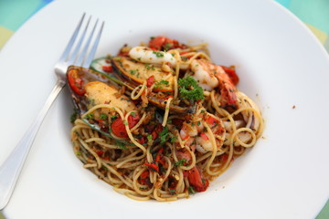 Spicy seafood spaghetti on white plate