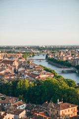 Fototapeta na wymiar Beautiful aerial city view of traditional old architecture and river bridges in Verona in Italy.