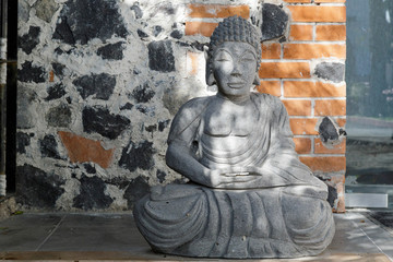 Buddha statue made of rock with rock background